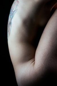 Tattoo on back, cuts on thighs