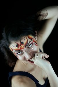 Juliette in makeup biting her finger